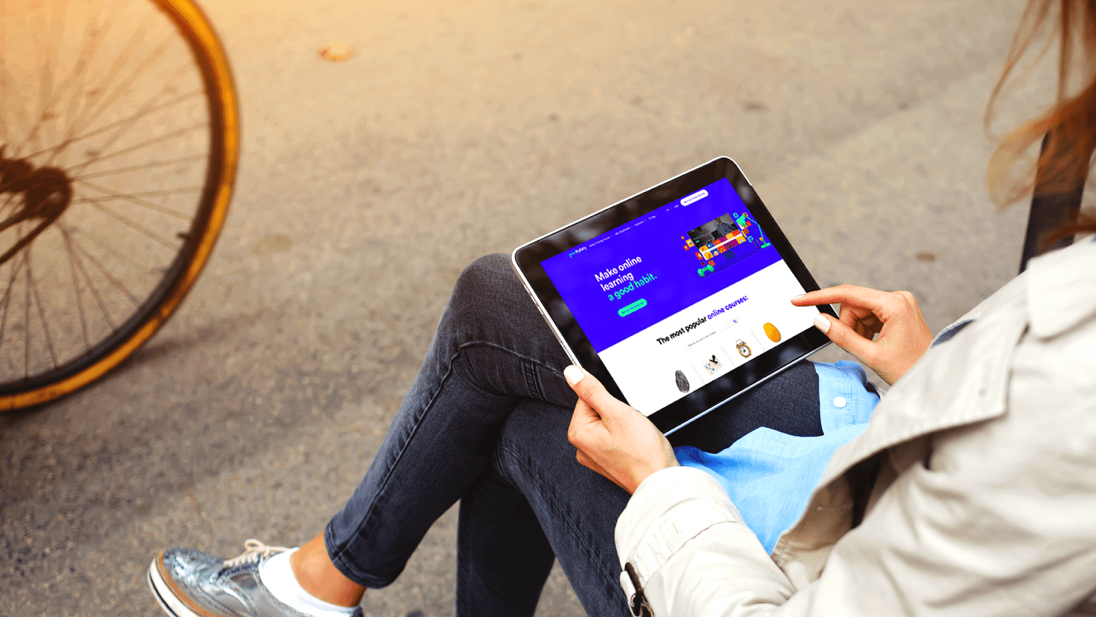 Image of a person sitting down, viewing the Goodhabitz website on an Ipad in their lap.